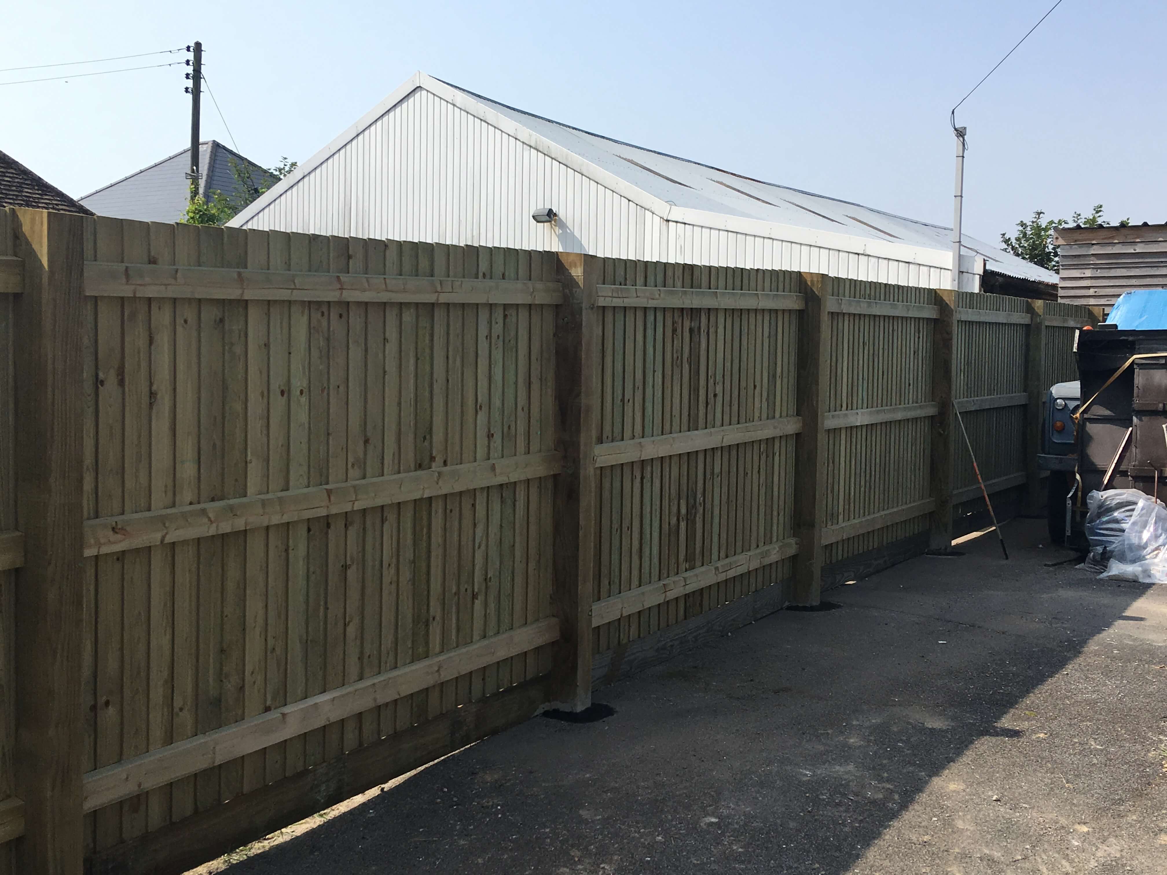 Traditional Featherboard Fencing Run on slope Robert Smith Fencing Solutions Ltd.