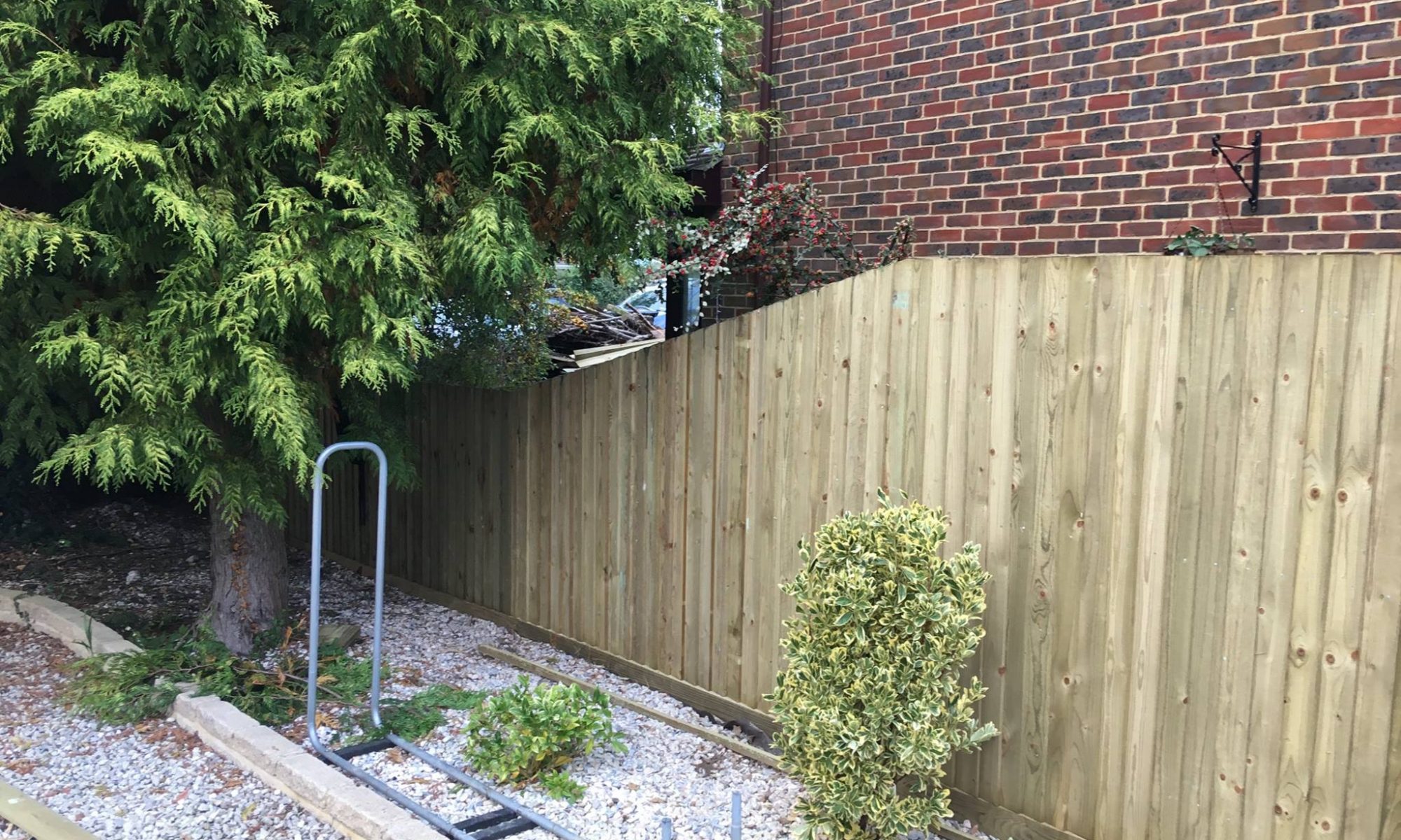 Traditional Featherboard Timber Fencing with decline at end